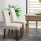 Sedie da pranzo in tessuto di lino beige con schienale borchiato, gambe in legno massello - Set da 2